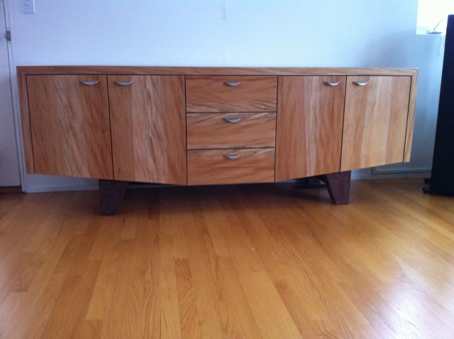 dresser- sycamore and walnut base. features 3 drawers in the center and 2 drawers in each side behind the doors~80